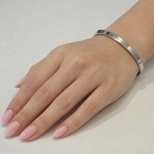 Silver colored monogramed bracelet that opens with pull. New without tags. #154